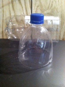 Cut the bottle where it starts to taper. Leave the lid on for extra stability.